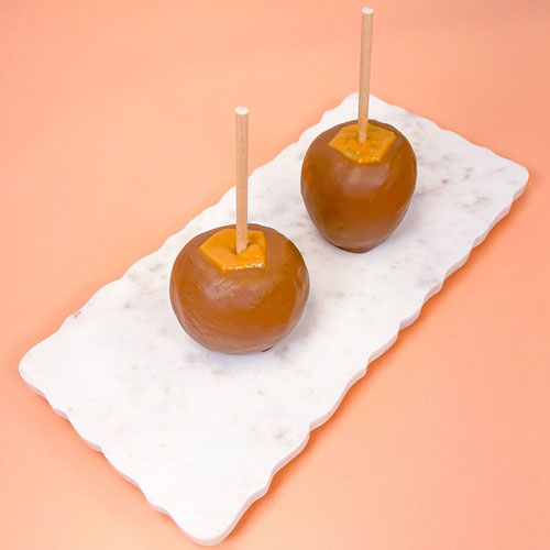 two chocolate dipped caramel apples