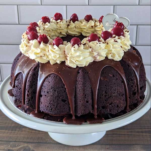chocolate bundt cake topped with cherries