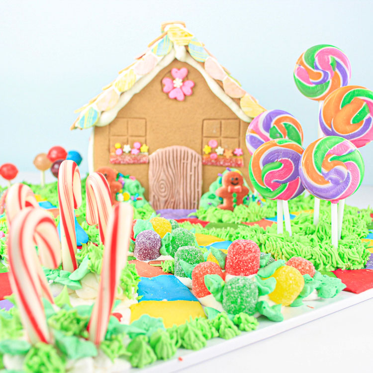 gingerbread house on candyland game board made out of cany and buttercream
