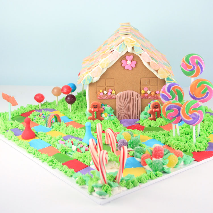 gingerbread house on candyland game board made out of cany and buttercream