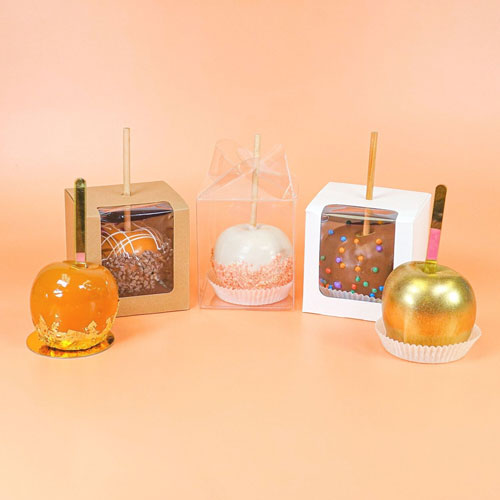 five decorated caramel apples in different packaging options