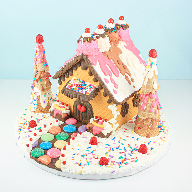 gingerbread house made out of ice cream sundae ingredients with melted ice cream roof