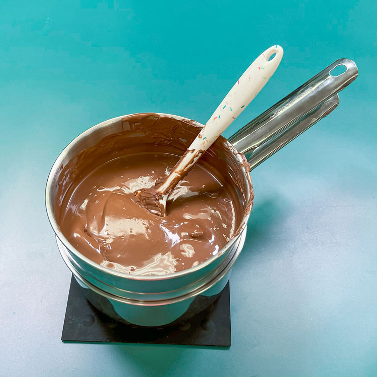 melted milk chocolate candy melts in a double boiler