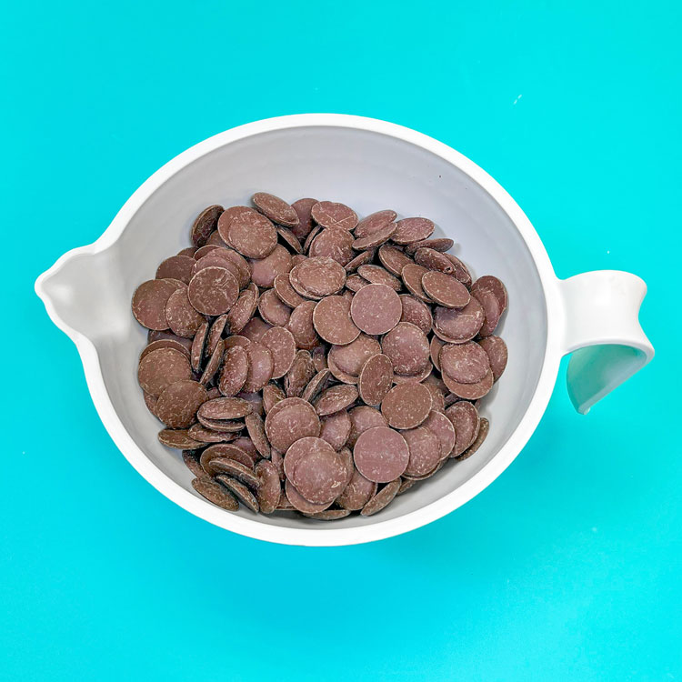 milk chocolate candy melts in a white bowl