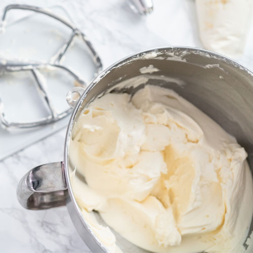 batch of buttercream icing with meringue powder in steal bowl