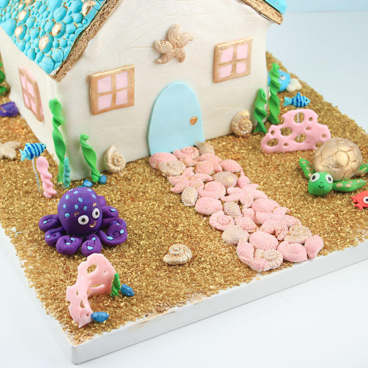 gingerbread house in underwater scene with sea creatures