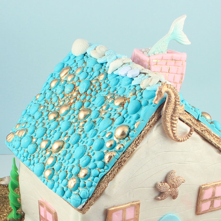 gingerbread house in underwater scene with sea creatures