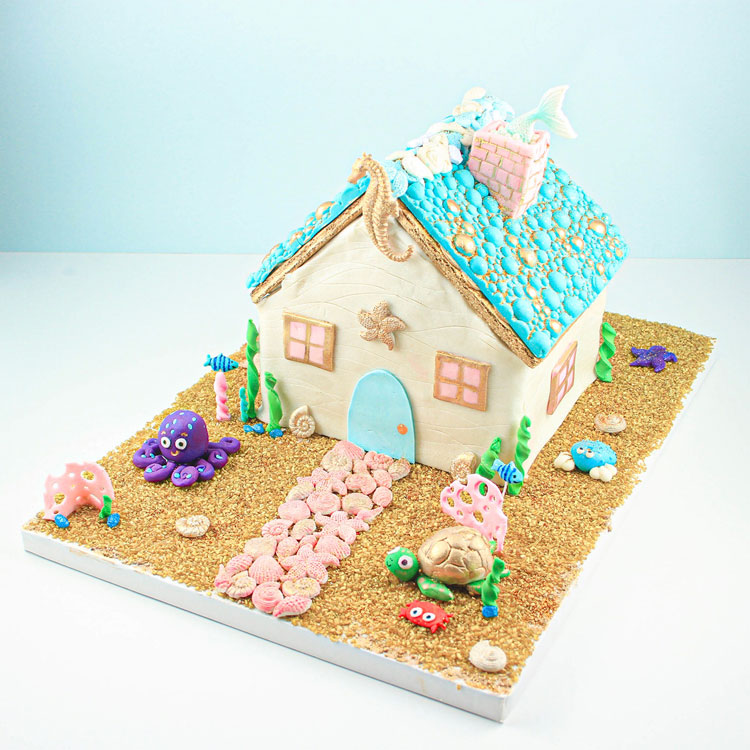 gingerbread house in underwater scene with sea creatures