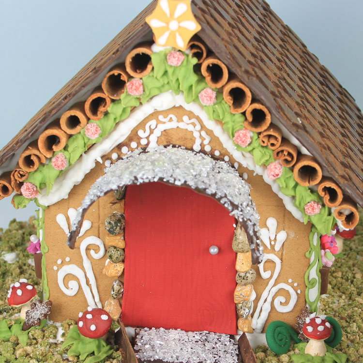 woodland inspired gingerbread house with gnome and chocolate accents