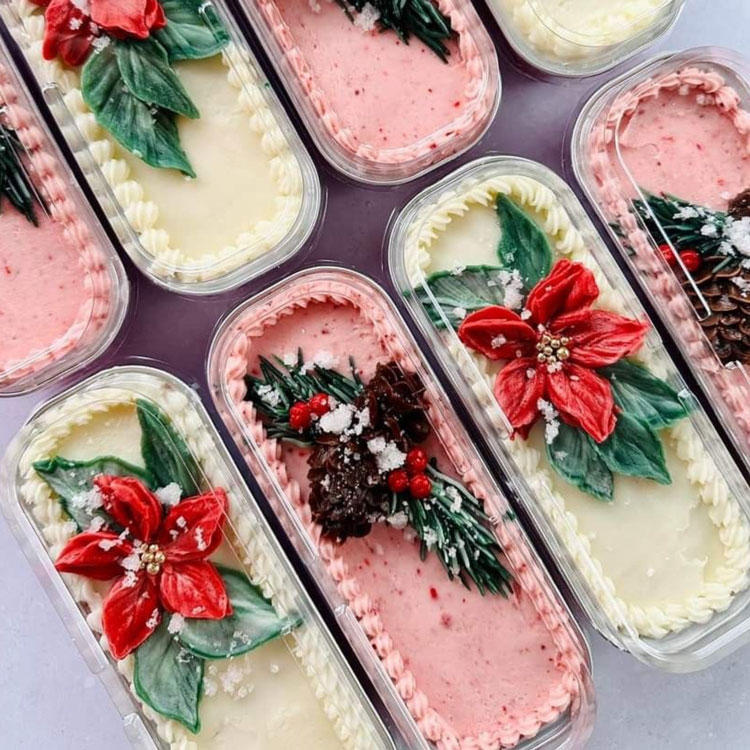 mini loaf cakes decorated with poinsettias and pine for christmas