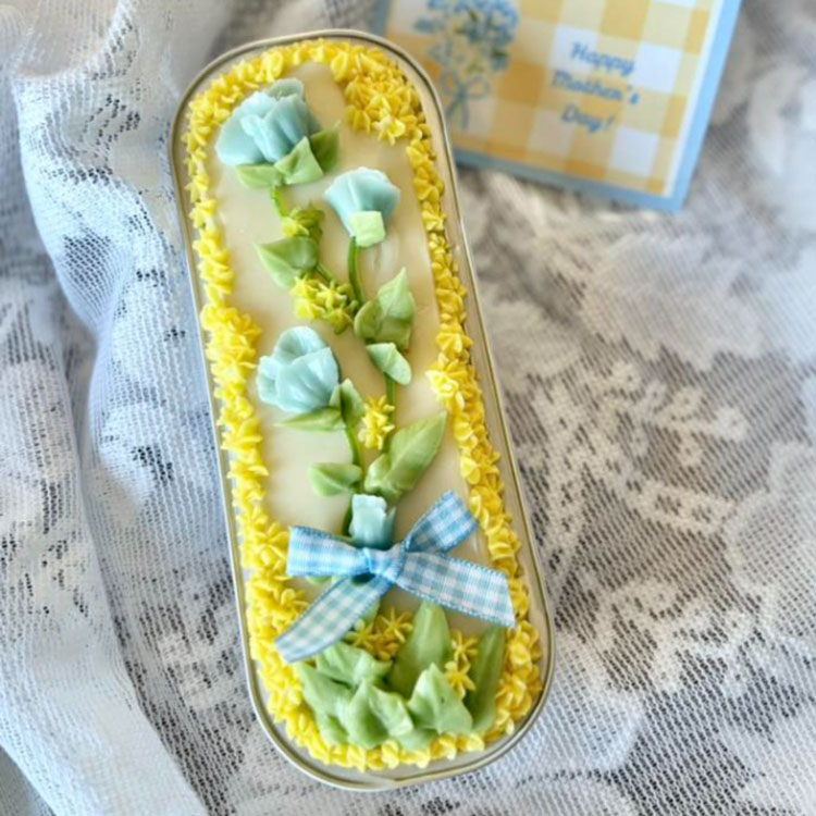 delicate blue flowers on a mini loaf cake