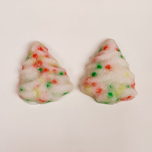 two christmas tree shaped buttermints with sprinkles