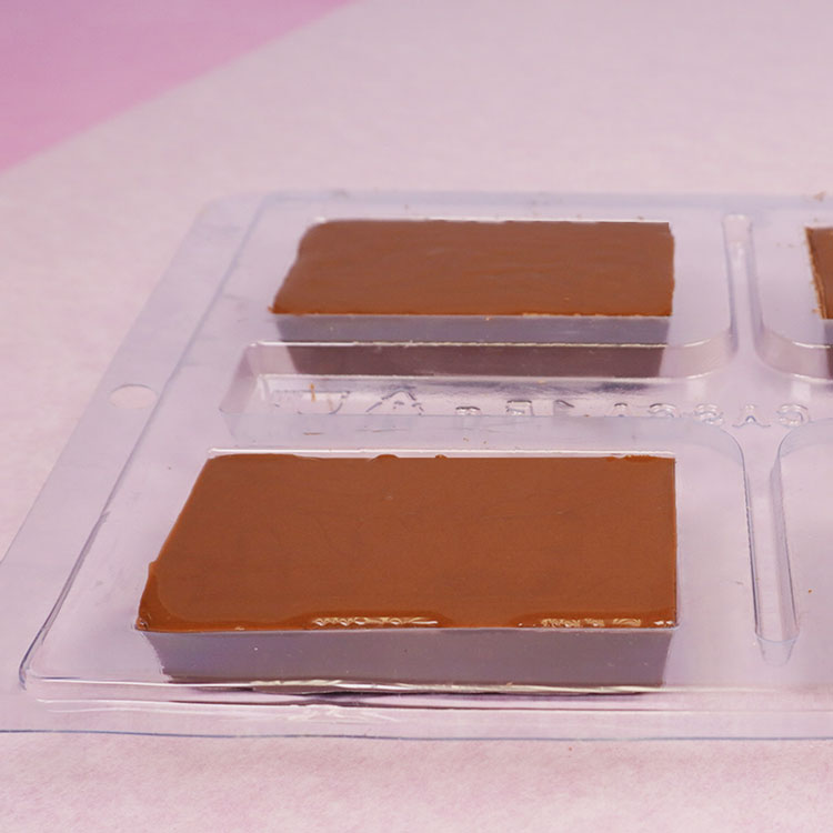 covering the top of the candy bar shell with chocolate