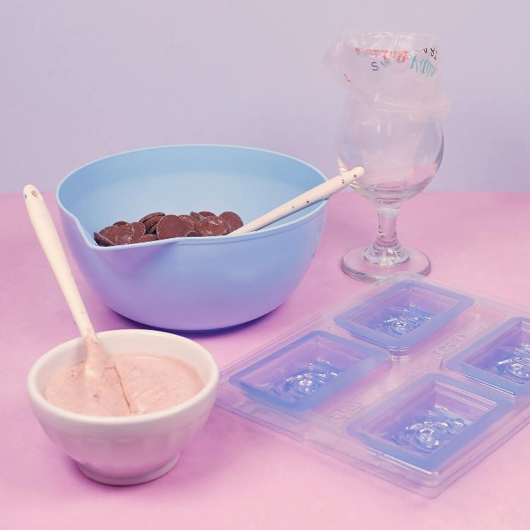 set-up for using bwb chocolate mold - bowl with chocolate, candy center, mold