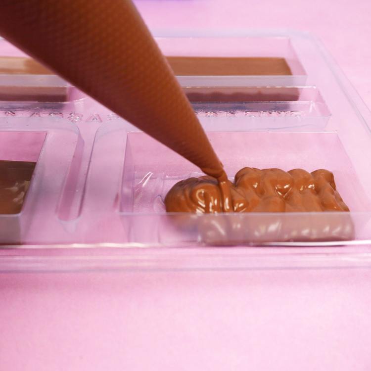 adding melted chocolate to bwb chocolate mold