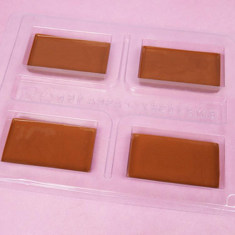 four cavities of a bwb chocolate mold filled to the line