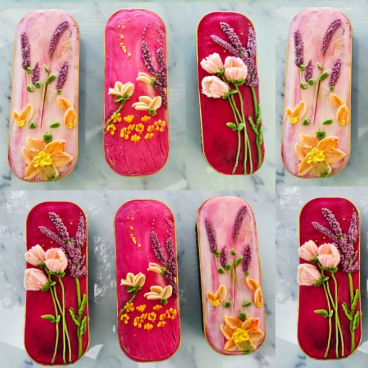 dainty piped flowers in shades of pinks, purples, and yellow on mini loaf cakes
