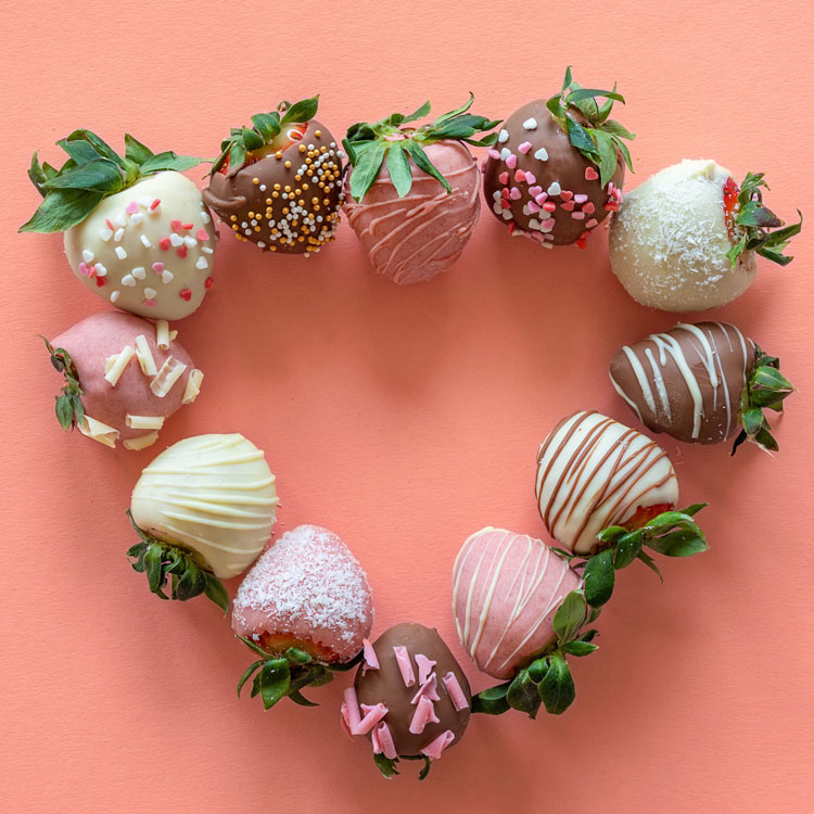 close-up of strawberries in a bowl being washed