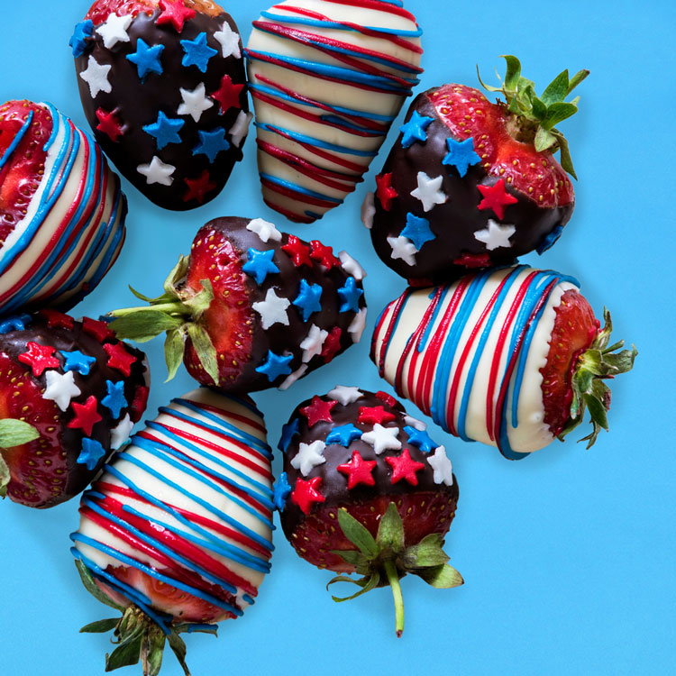 close-up of strawberries in a bowl being washed