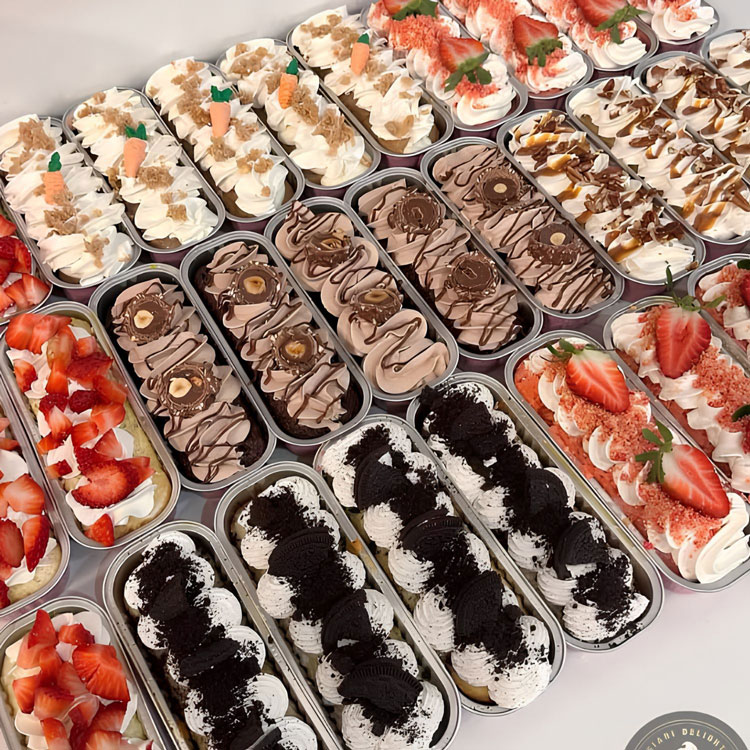 table filled with different flavors of mini loaf cakes