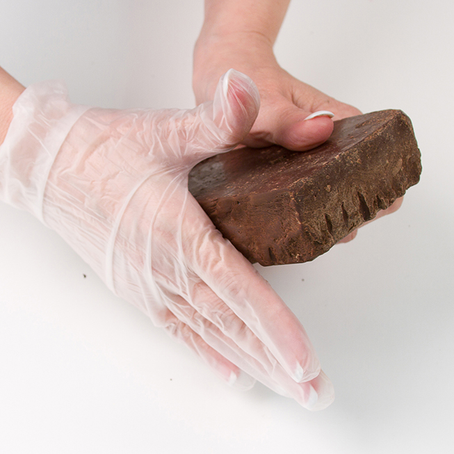 Rub the edge of the bar to soften the chocolate. 