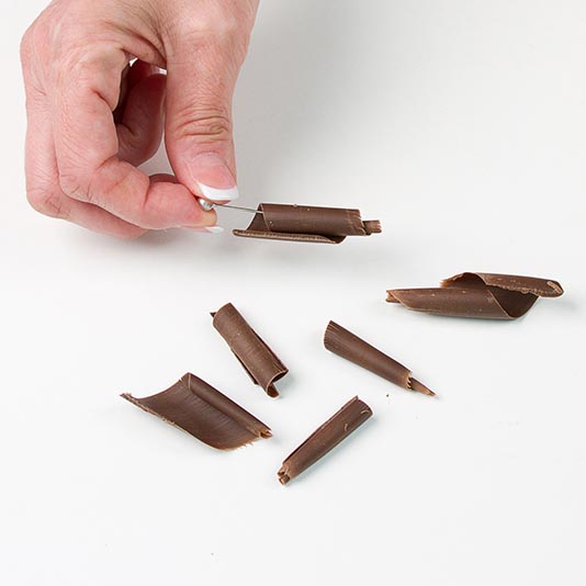 Use a toothpick to gently lift and place the curls onto your finished desserts.