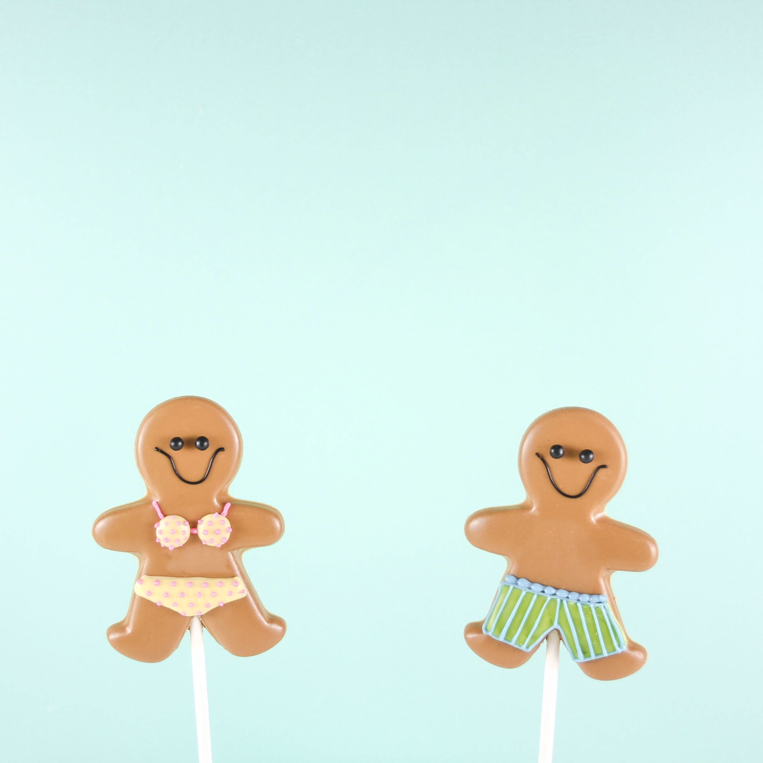 Gingerbread boy and girl in swimsuits molded chocolate sucker