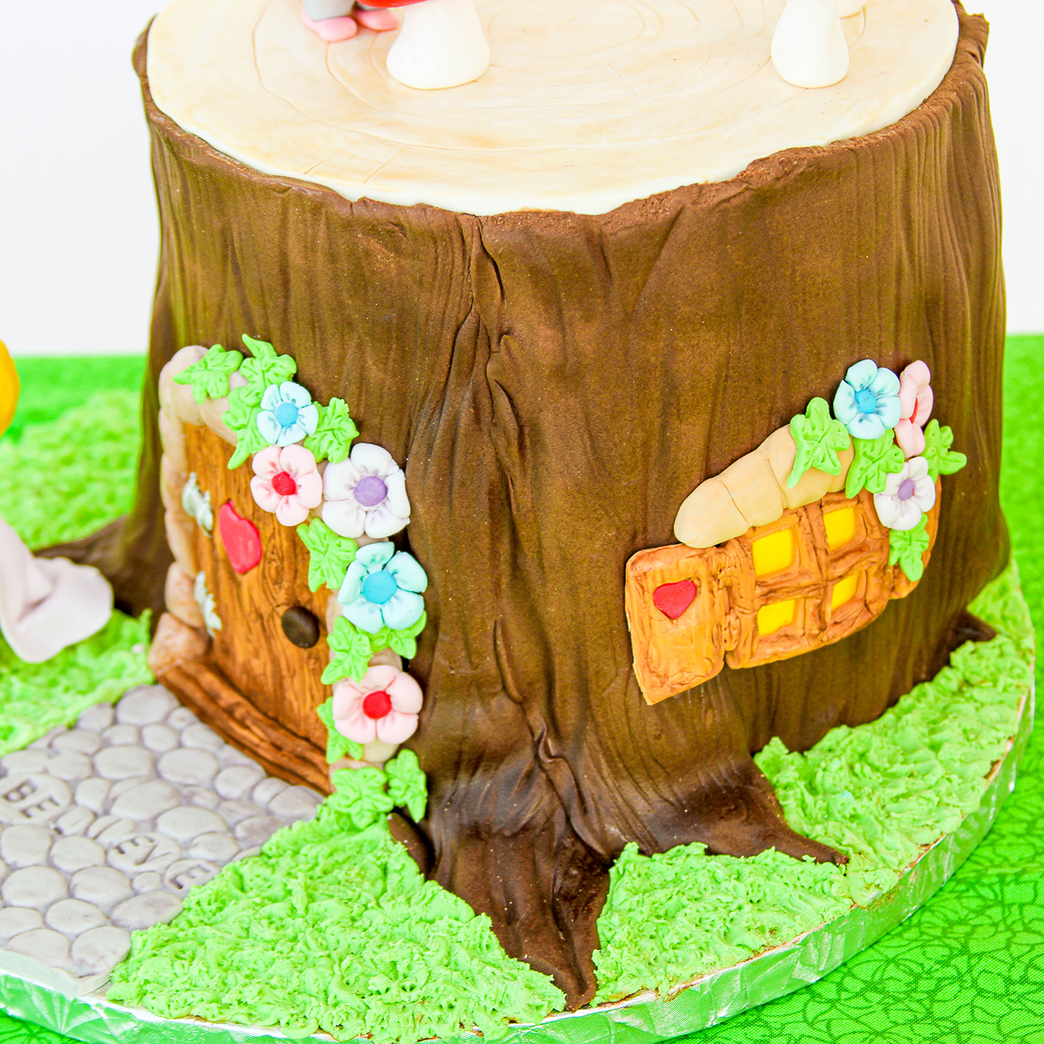 Side view of the fairy's tree trunk house with carrot covered side window.