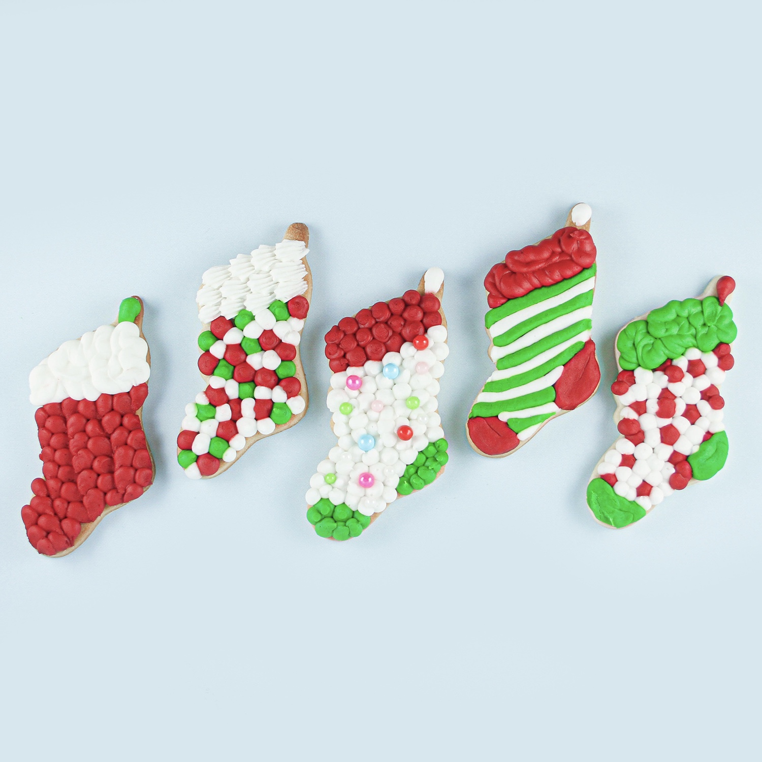 Stocking Buttercream Cream Sugar cookies piped with open round tip number six, piping dots, stripes, pulled dot for cable knit sweaters