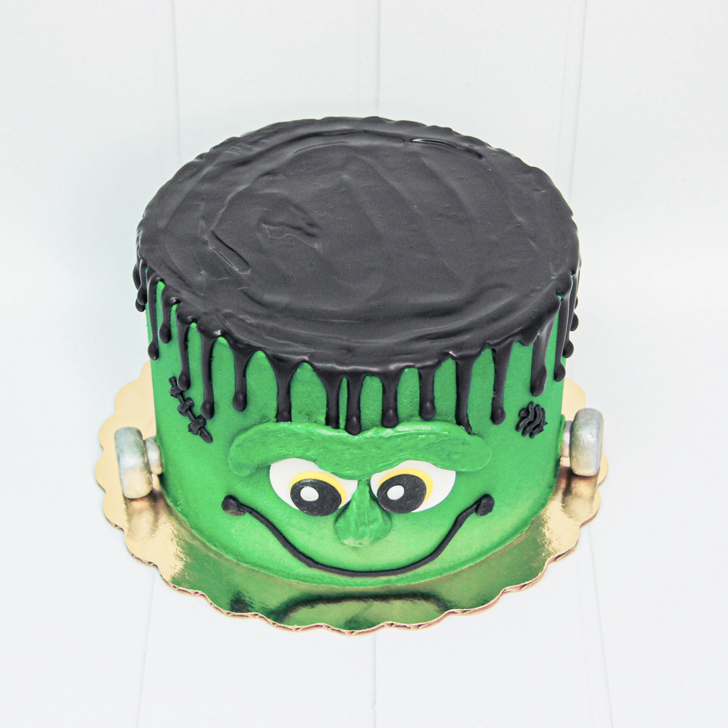 Top of frankenstein cake made in a chocolate drip.