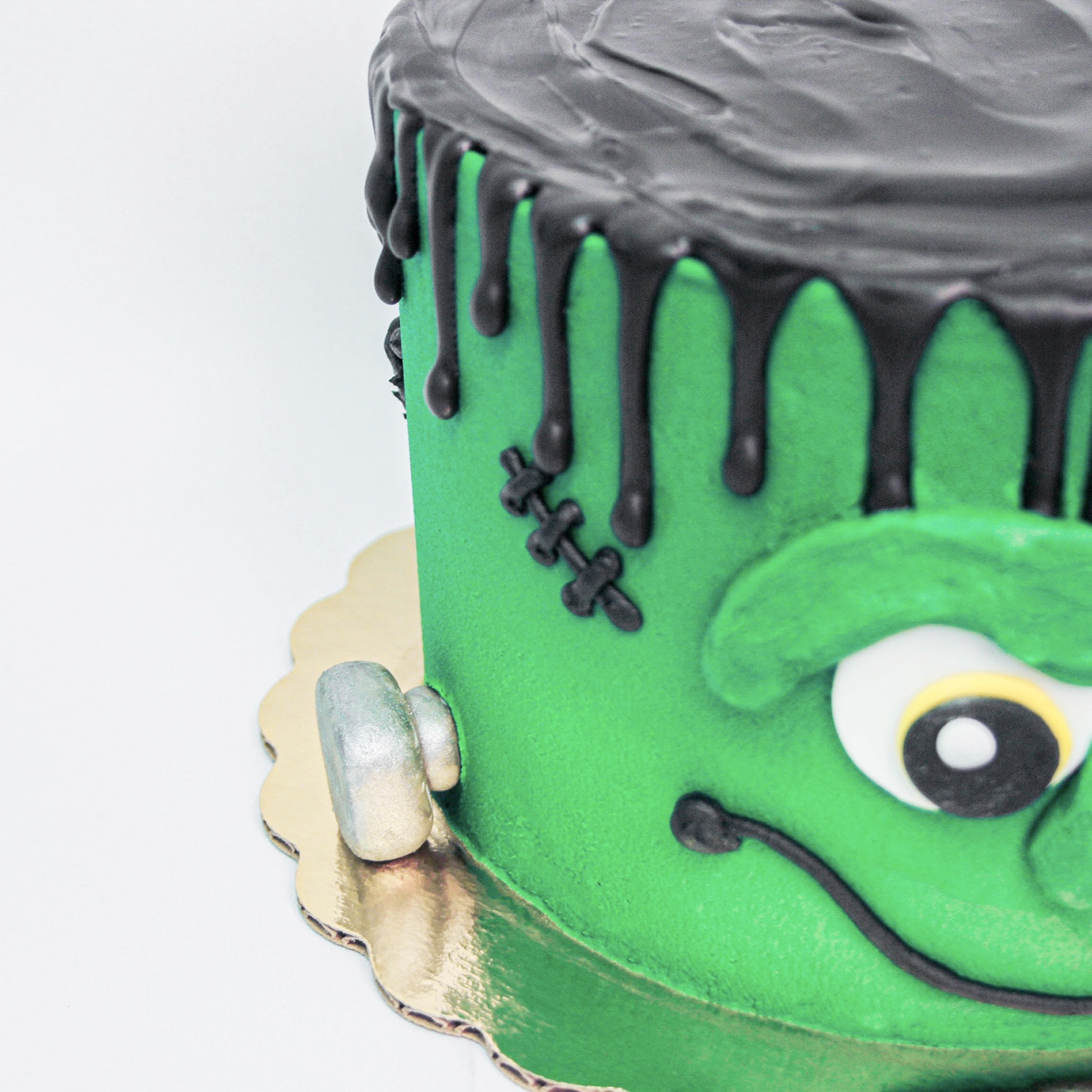 Frankenstein cake showing the fondant silver painted bolts and scar