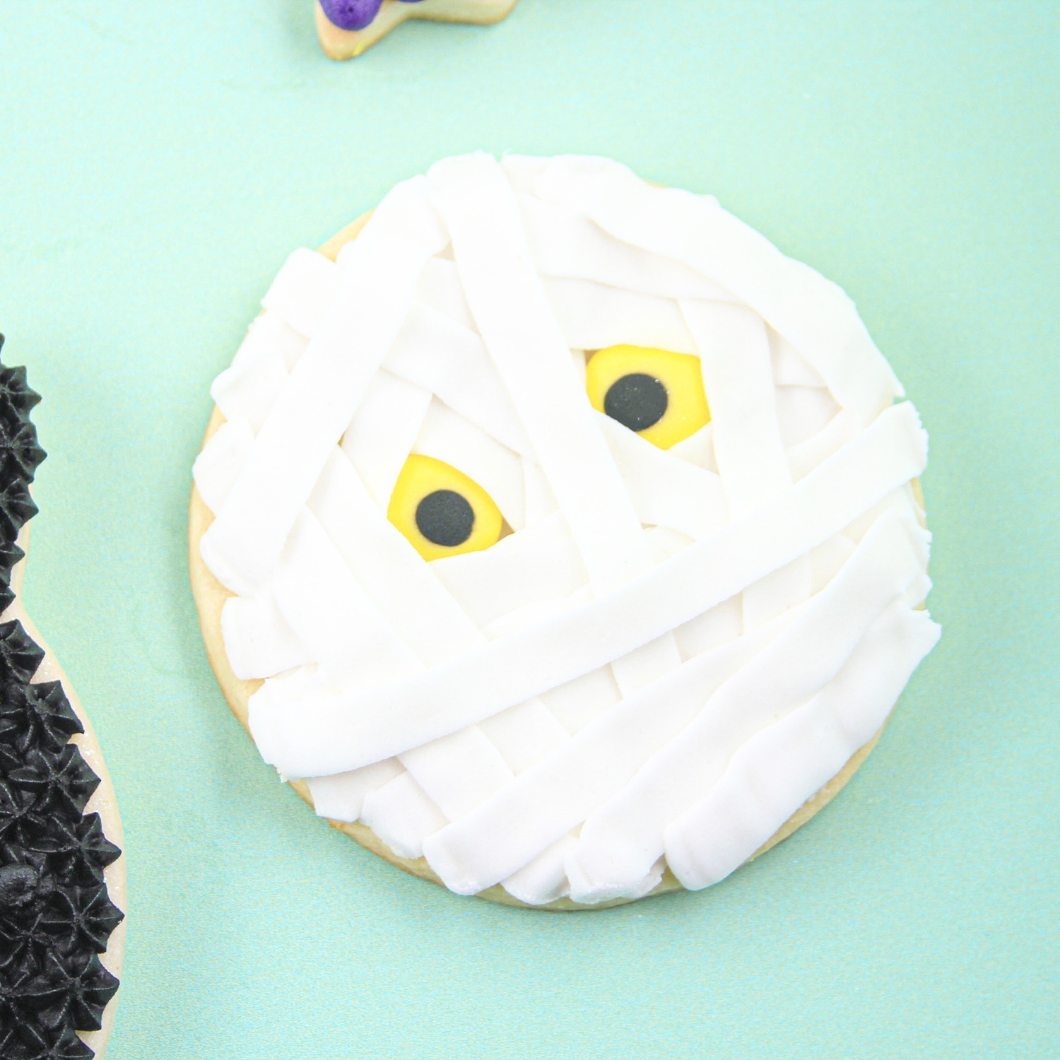 Mummy Cookie with cloth ribbons of buttercream and yellow eyes