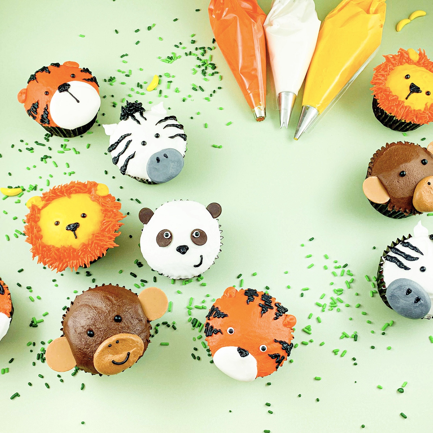 Cupcakes decorated to look like a zebra, panda, monkey, tiger, and lion.