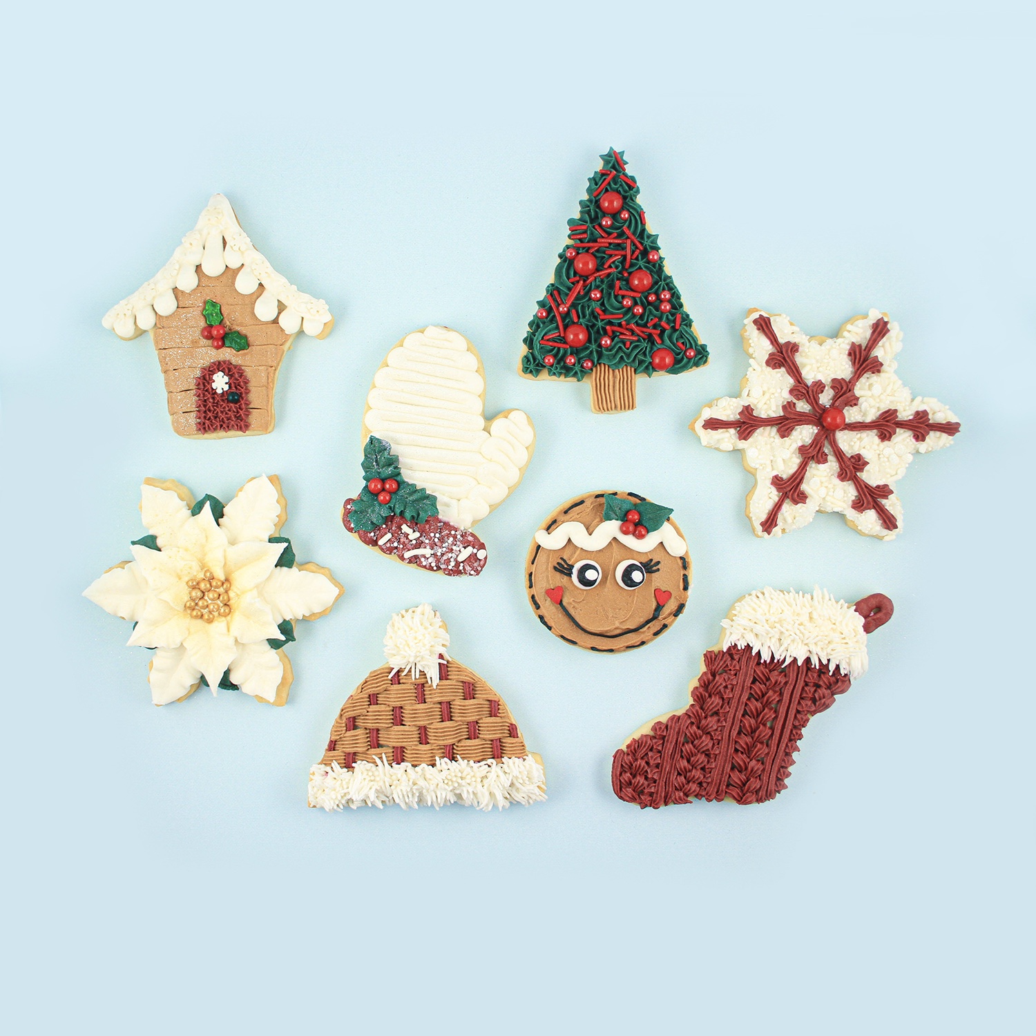 Christmas Buttercream Cookies, house, mitten, hat, tree, snowflake, poinsettia, stocking and gingerbread girl decorated with ivory, brown, red and green color palette and adorned with sprinkles