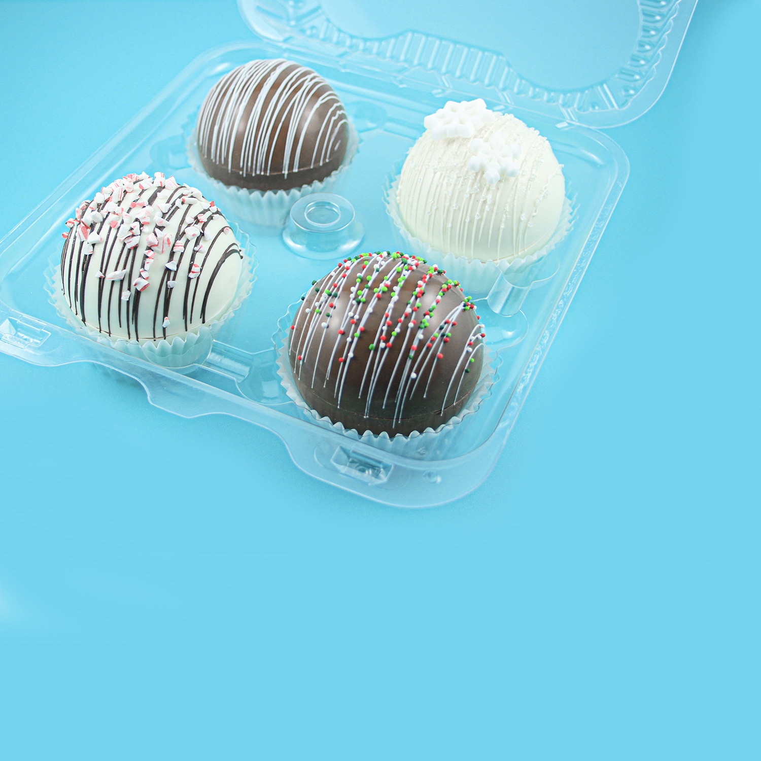 Hot Cocoa Bombs in dark, milk, white chocolate with drizzle and sprinkles