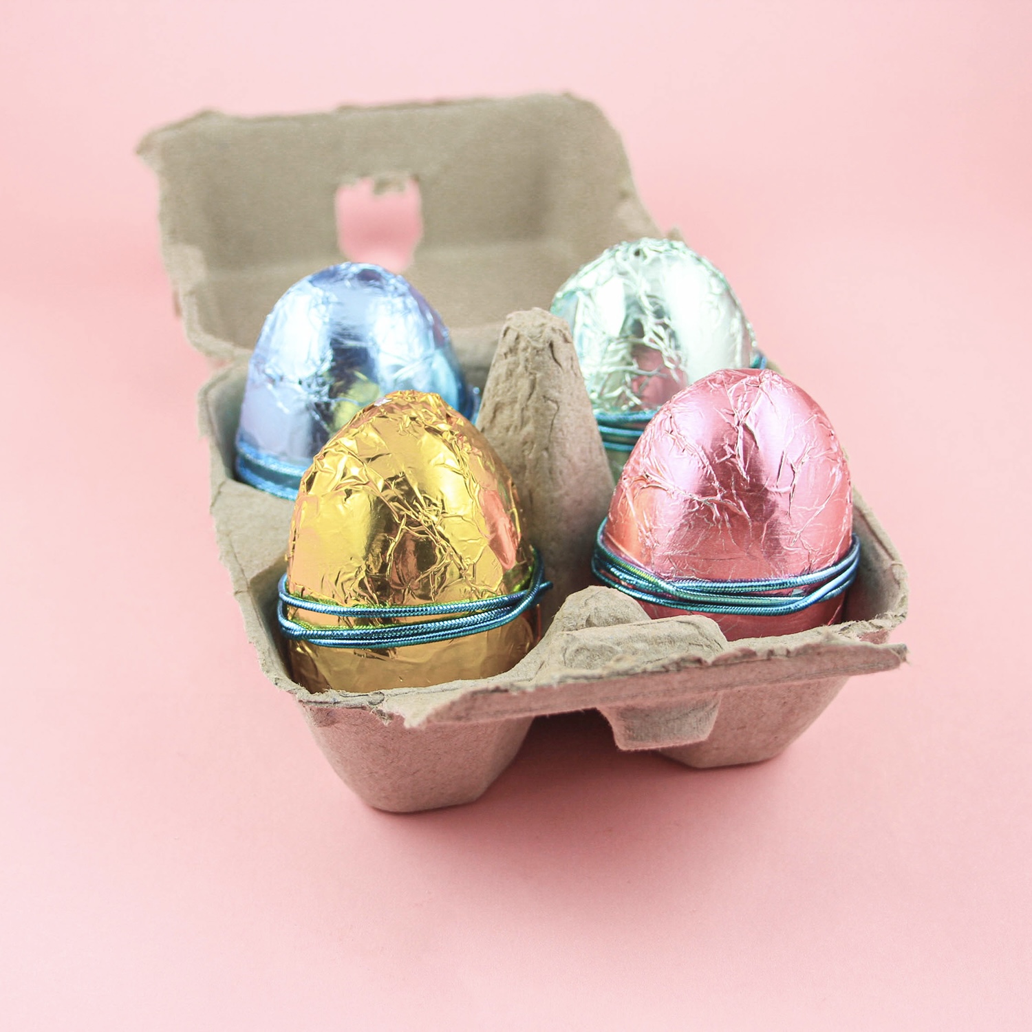 Buttercream Filled Chocolate Eggs wrapped in colored foil in a 4-pack egg carton