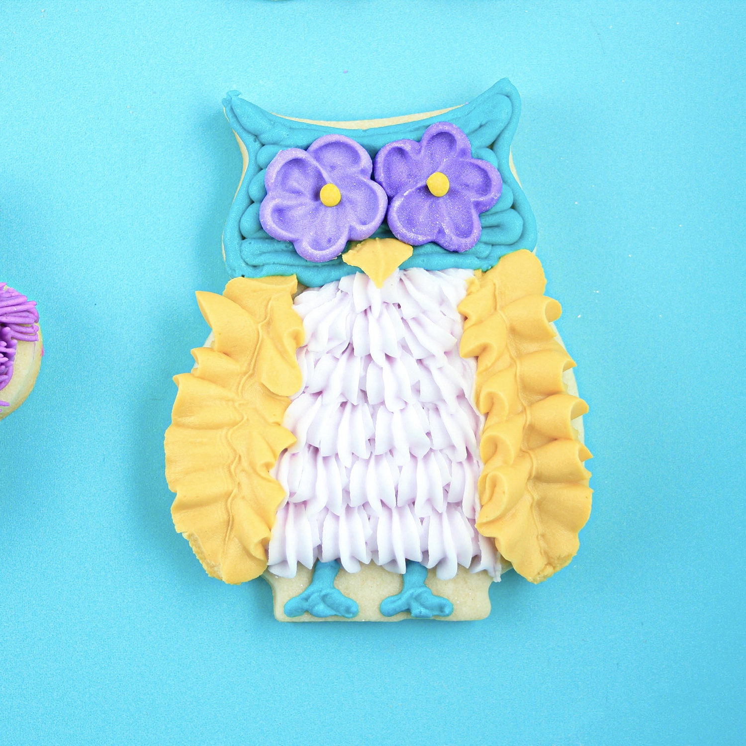 Owl Cookie decorated with buttercream ruffles