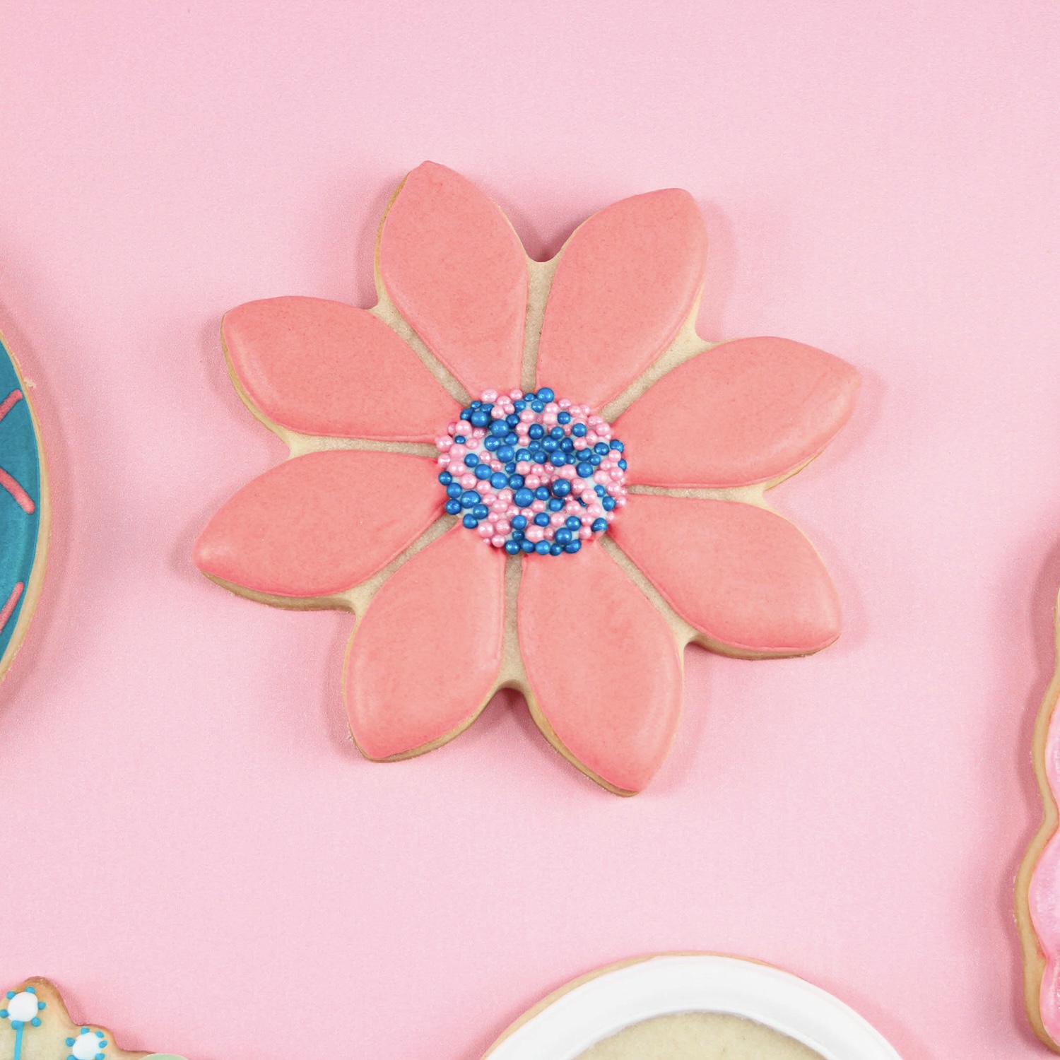 Royal Icing decorated flower cookies with pink and blue nonpareils center