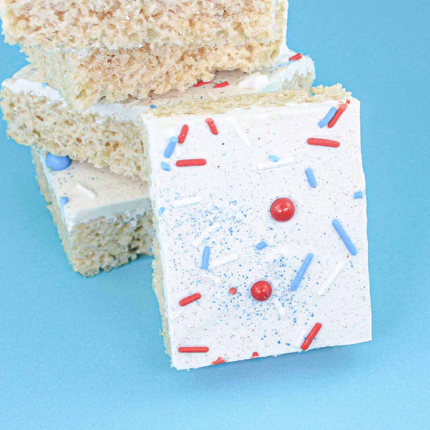 Rice krispie treat coated in white chocolate, patriotic sprinkles and sparkling dusts