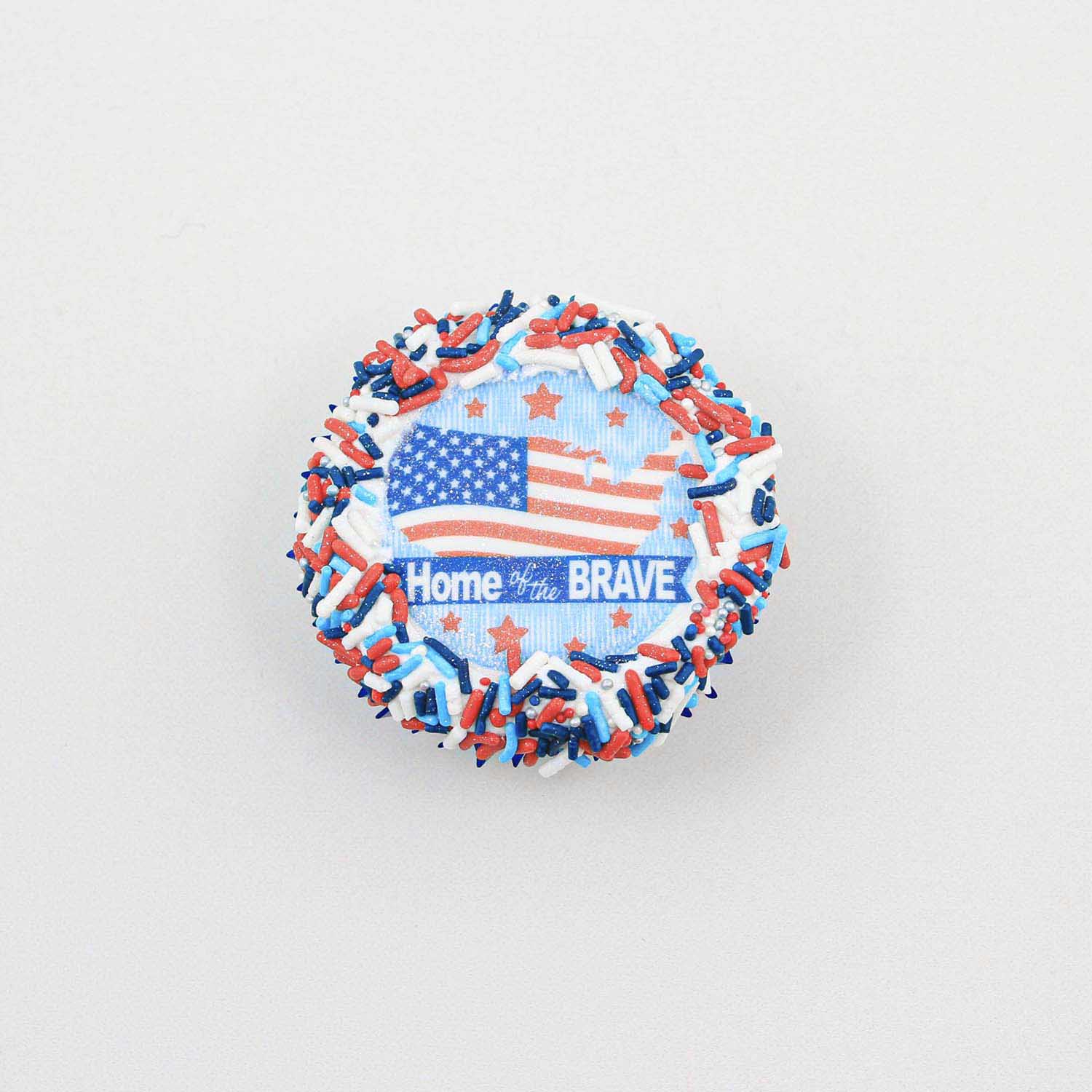 Home of the brave edible image cupcake topper with white buttercream and red white and blue jimmies