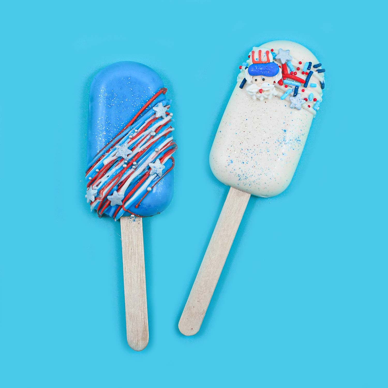 Blue cakesicle with red, white and blue drizzle, silver nonpareil and star sprinkels. White cakesicle with white chocolate drizzle, red white and silver jimmies and nonpareils and stars and uncle sam layons.