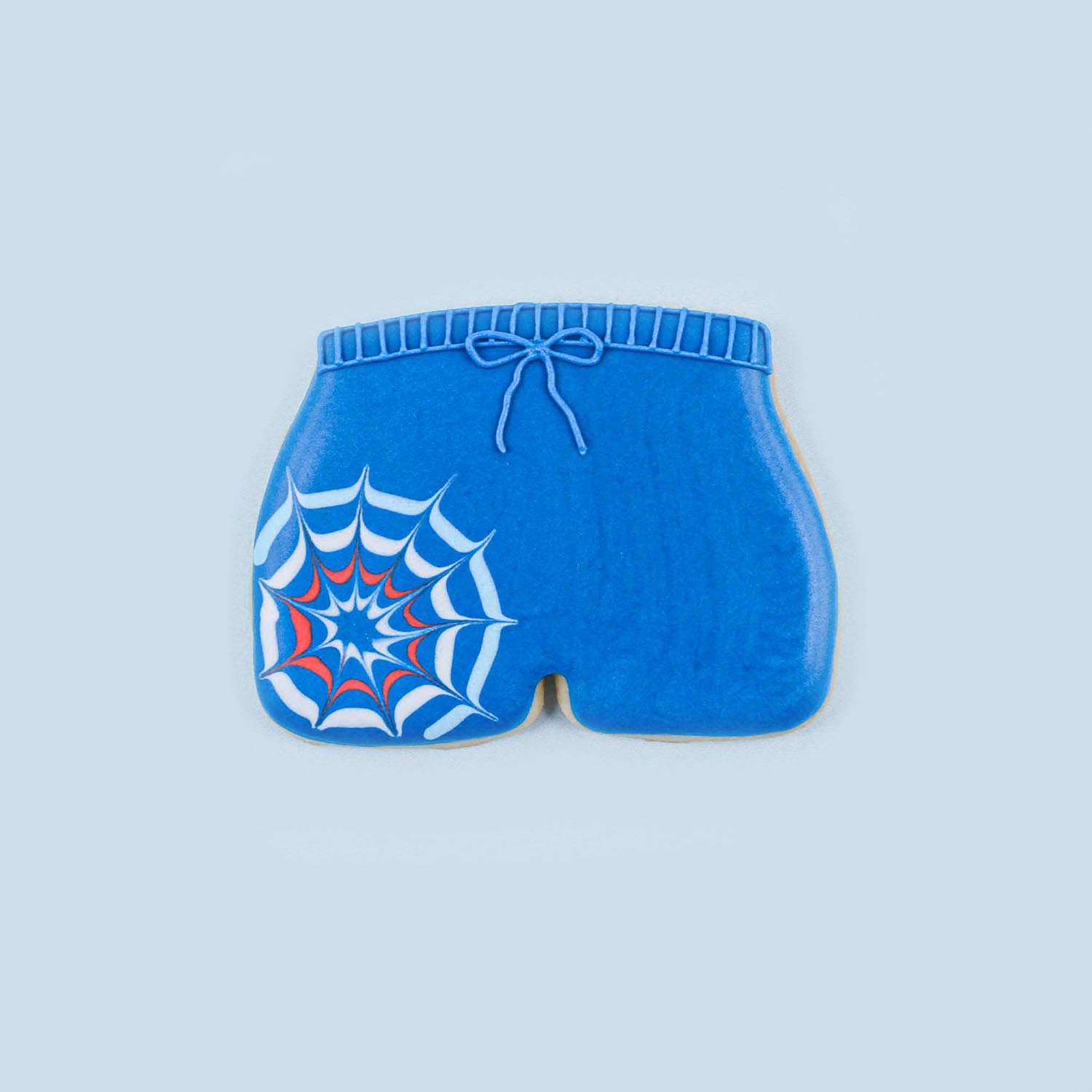 Navy blue swim trunk cookie with firework explosion on shorts
