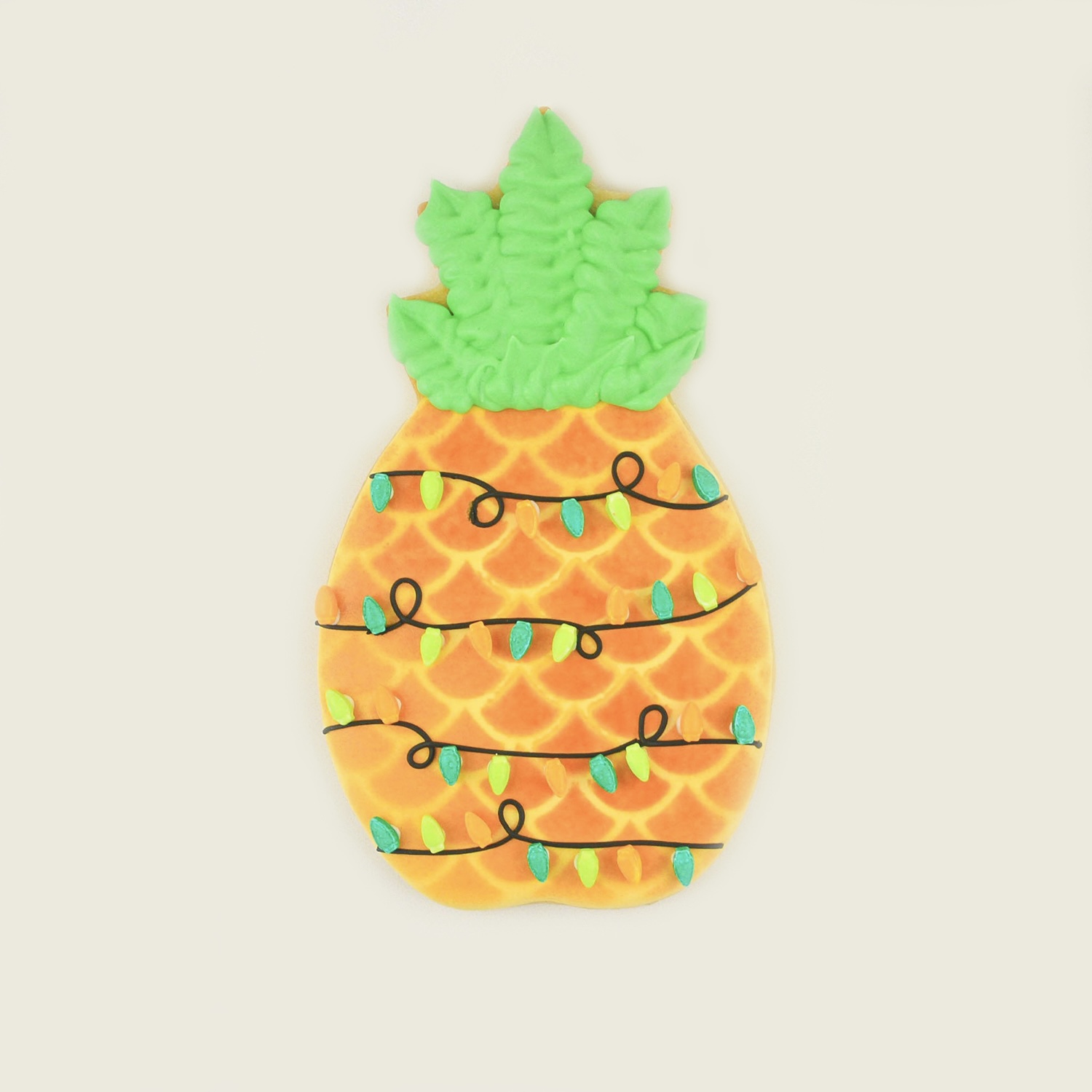 Pineapple Royal Icing Cookie with airbrushed accents and adorned with Christmas lights