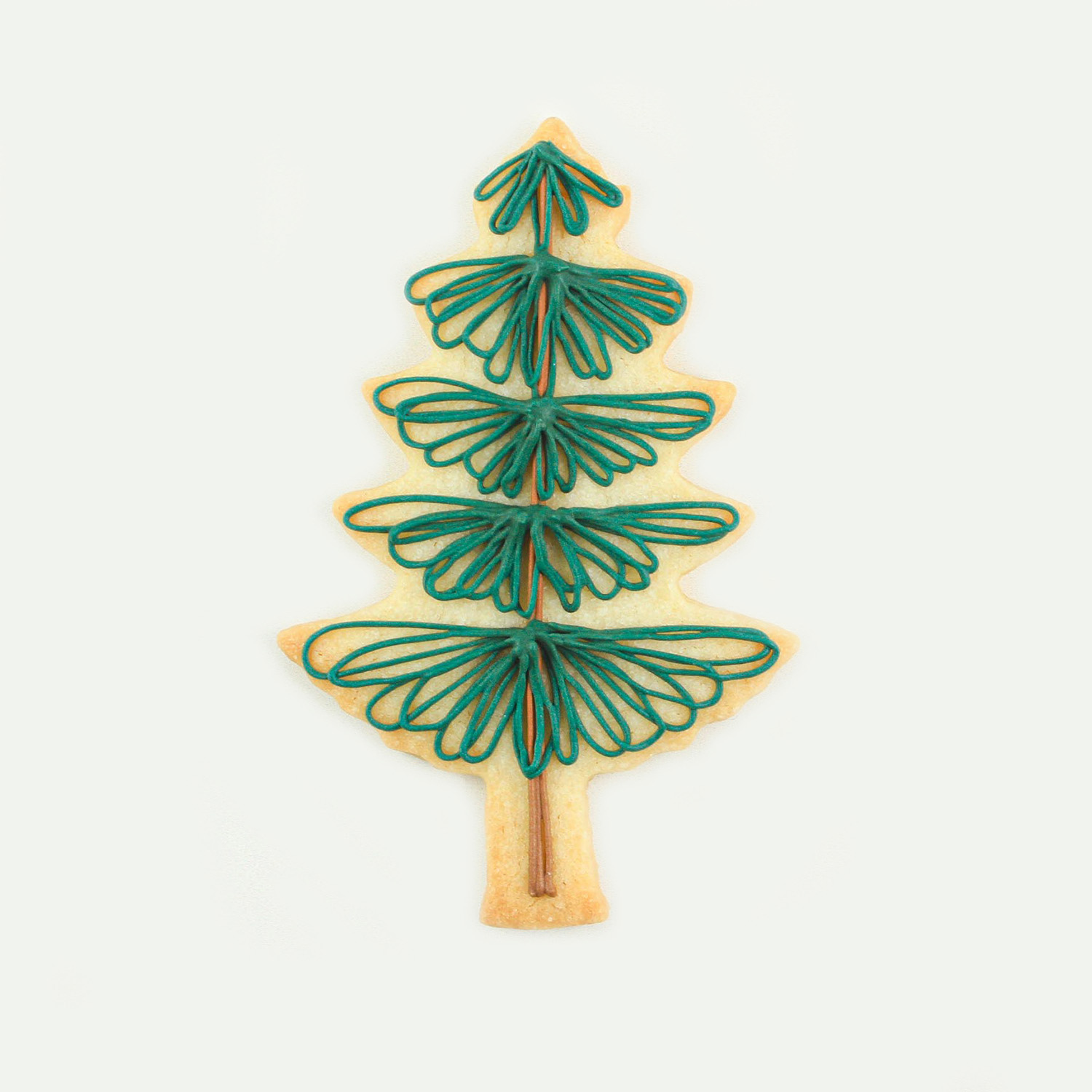 Pine Tree Cookie decorated with loops of green royal icing for the leaves