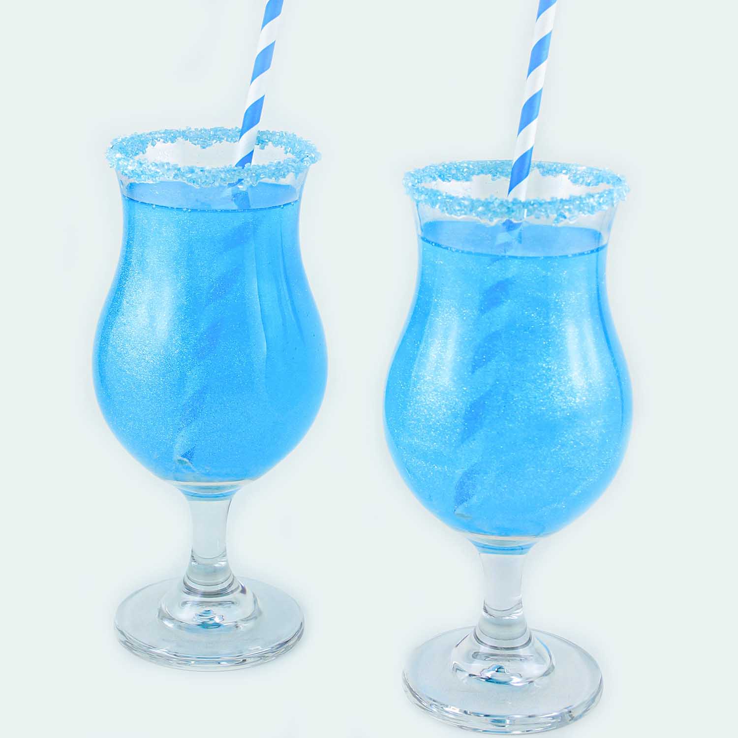 blue raspberry drink with edible glitter and sugar rim