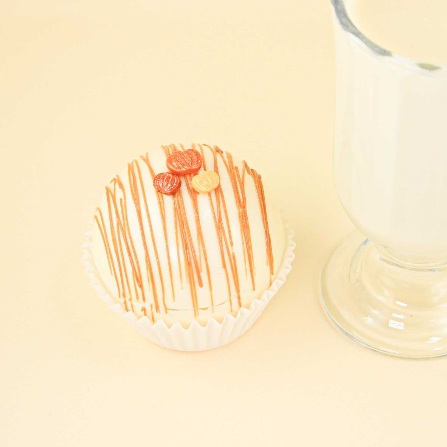 pumpkin spice hot chocolate bomb with pumpkin sprinkles