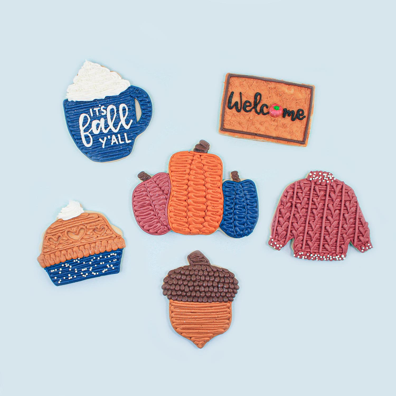 Pumpkins, Pie, Cable Knit Sweater, Mug , Welcome Mat and Acorn cookies decorated in buttercream.