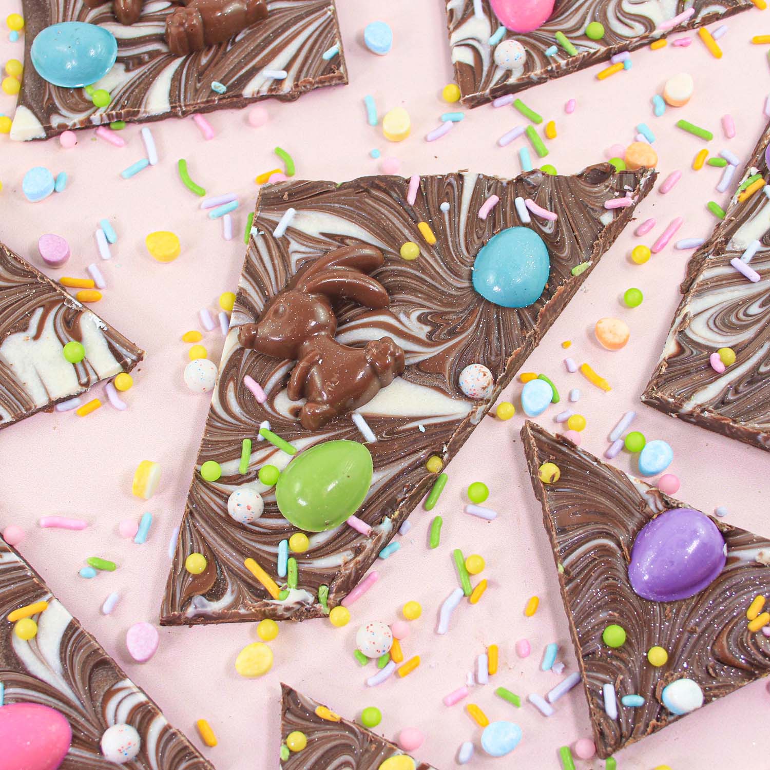 Dark, Milk and White Chocolate swirled together and topped with premade chocolate bunnies and colored chocolate jelly bean eggs and finished with edible glitter