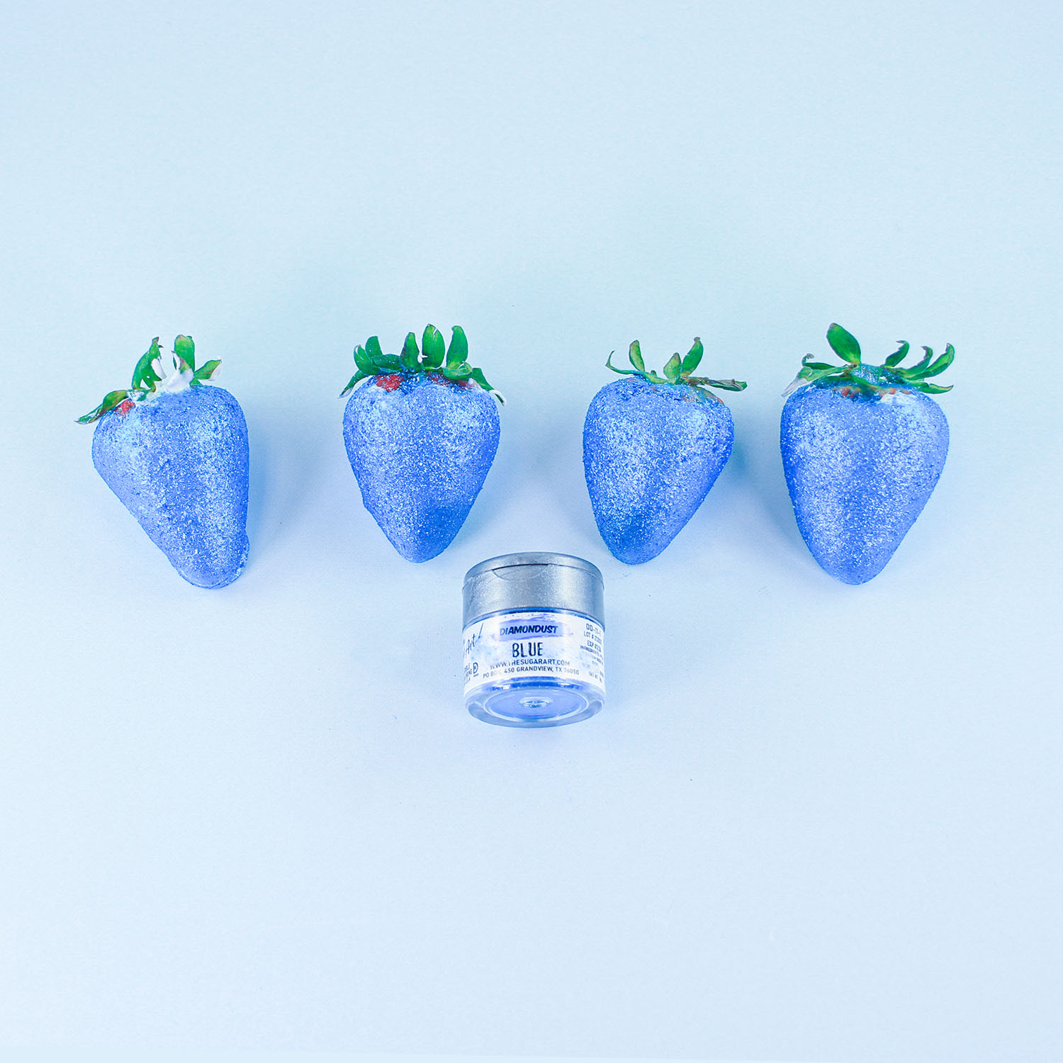 four blue glitter chocolate coated strawberries