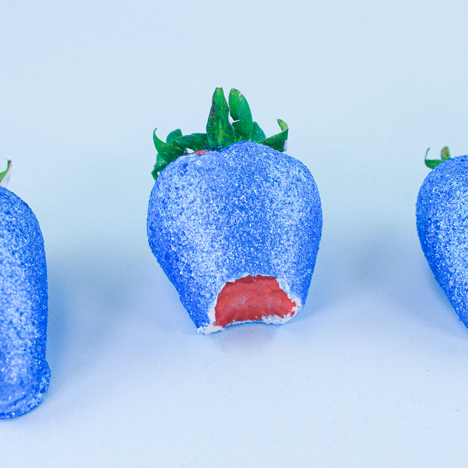 finished glitter strawberries sitting while cleaning up glitter